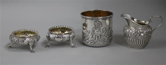 A silver mug, a pair of Victorian silver bun salts and a silver cream jug.